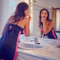 12 candid pics of Adele Taylor putting on makeup in the mirror